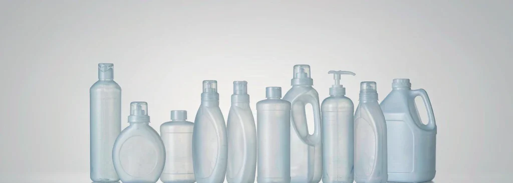 A row of blank household cleaning bottles used to illustrate packaging weight data for US state EPR reporting
