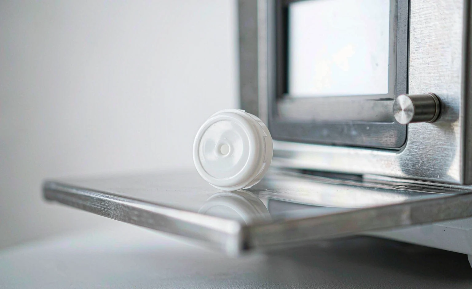 A packaging component being weighed on a precision scale